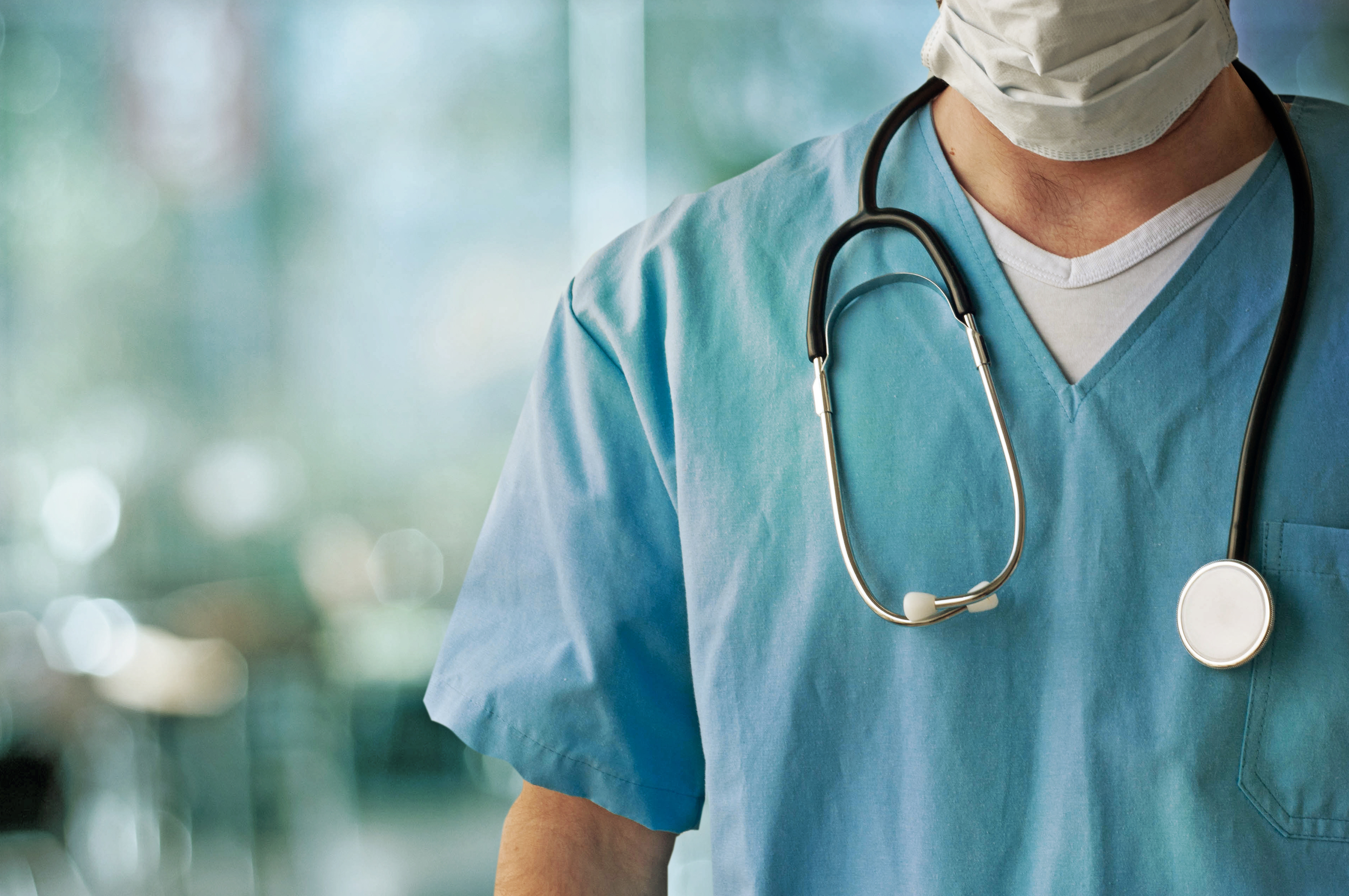 Doctor wearing blue scrubs and a stethoscope